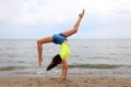 Girl on foreshore of the sea while performing gymnastic exer Royalty Free Stock Photo
