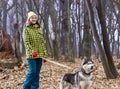 Girl in the forest with her husky dog