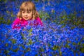 Girl among forget-me-nots flowers