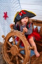 Girl in the form of pirates at the helm.