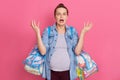 Girl freaking out, starting panic as realising its time to give birth, feels worried and anxious, holding two bags with stuff,