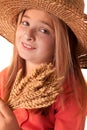 Girl with the freckles and straw hat holding in his hand a whe Royalty Free Stock Photo