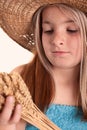 Girl with the freckles and straw hat holding in his hand a whea Royalty Free Stock Photo
