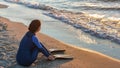 A girl free diver sits on the sea shore puts on her fins and prepares to snorkeling dive. Travel holiday lifestyle