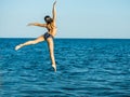 Girl in a free flying leap into the sea