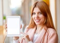 Girl freelancer holding a tablet in the office