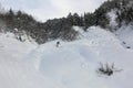 girl freerides on a snowboard on the background of the peak of Ushba in the resort of Tetnuldi, Mestia, Svaneti, Caucasus