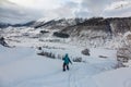 Girl freerides on a snowboard on the background of the peak of Ushba in the resort of Tetnuldi, Mestia, Svaneti, Caucasus