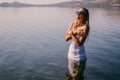 A girl is freezing in a cold lake