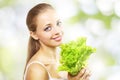 Girl with a fresh green lettuce leaf Royalty Free Stock Photo