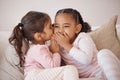 Girl, friends or children whisper secret to best friend on home sofa while relax together on play date. Communication Royalty Free Stock Photo