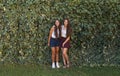 Girl friends, happy and portrait outdoor with laugh, leaves and students with a smile in a park. Garden, youth and hug Royalty Free Stock Photo