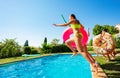 Girl with friends jump dive into swimming pool Royalty Free Stock Photo