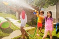 Girl and friends play water gun fight game outside Royalty Free Stock Photo