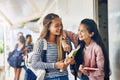 Girl friends, student and school with laughing and books with smile on campus. Teenager, young teen and girls with Royalty Free Stock Photo