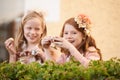 Girl, friends and tea cup in garden for party snack for happy dress up game, fantasy or play. Female people, nature and Royalty Free Stock Photo