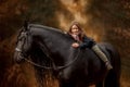 Girl with friesian horse autumn forest