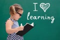 Girl In Front Of Chalkboard With I Love Learning Text