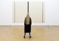 Girl in front of painting by barnett newman in museum