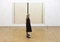 Girl in front of painting by barnett newman in museum