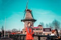 Girl in front of a windmill in Amsterdam, Netherlands