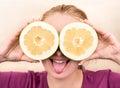 Girl with fruit halves Oroblanco Royalty Free Stock Photo