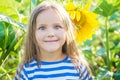 Girl with funny face among sunflower filed Royalty Free Stock Photo