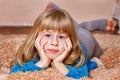 Girl with funny tails is lying on the carpet