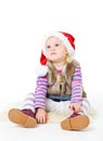 Girl in a fur jacket and a red Santa's cap Royalty Free Stock Photo