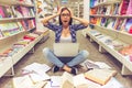 Girl with gadget at the bookshop Royalty Free Stock Photo