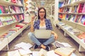 Girl with gadget at the bookshop Royalty Free Stock Photo