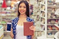 Girl with gadget at the bookshop Royalty Free Stock Photo