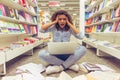 Girl with gadget at the bookshop Royalty Free Stock Photo