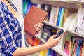 Girl with gadget at the bookshop Royalty Free Stock Photo