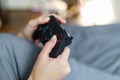 Girl gamer playing video game with wireless joystick at home. Gamepad in female hands close-up, gaming addiction concept, woman Royalty Free Stock Photo