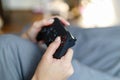 Girl gamer playing video game with wireless joystick at home. Gamepad in female hands close-up, gaming addiction concept, woman Royalty Free Stock Photo