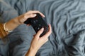 Girl gamer playing video game with wireless joystick at home. Gamepad in female hands close-up, gaming addiction concept, woman Royalty Free Stock Photo