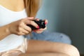 Girl gamer playing with a wireless controller, looking at the screen in front. Young girl eSports player smiling and enjoying the