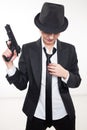 Girl gangster holding a gun. Classic suit and hat.