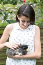 Girl In Garden Looking After Pet Guinea Pig Royalty Free Stock Photo