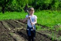 Girl in the garden with a shovel Royalty Free Stock Photo