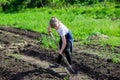 Girl in the garden with a shovel Royalty Free Stock Photo