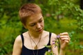 The girl in the garden smelling a flower