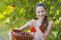 Girl in garden with a sweet cherry basket