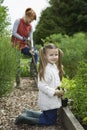 Girl Gardening With Mother In Field Royalty Free Stock Photo