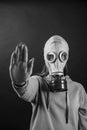 Girl in a gas mask with an outstretched hand on a black background, close up Royalty Free Stock Photo