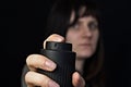 Girl with a gas, pepper spray, close-up, black background Royalty Free Stock Photo