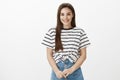 Girl gathers courage to say important words to boyfriend. Attractive european woman in trendy striped t-shirt, touching Royalty Free Stock Photo