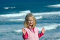 Girl gesturing stop by sea