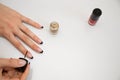 girl get a new manicure on a white backgound. the process of applying manicure